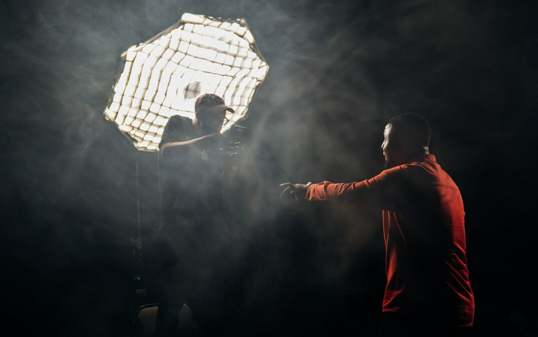 Studio lighting rig with softboxes and grid above a television set